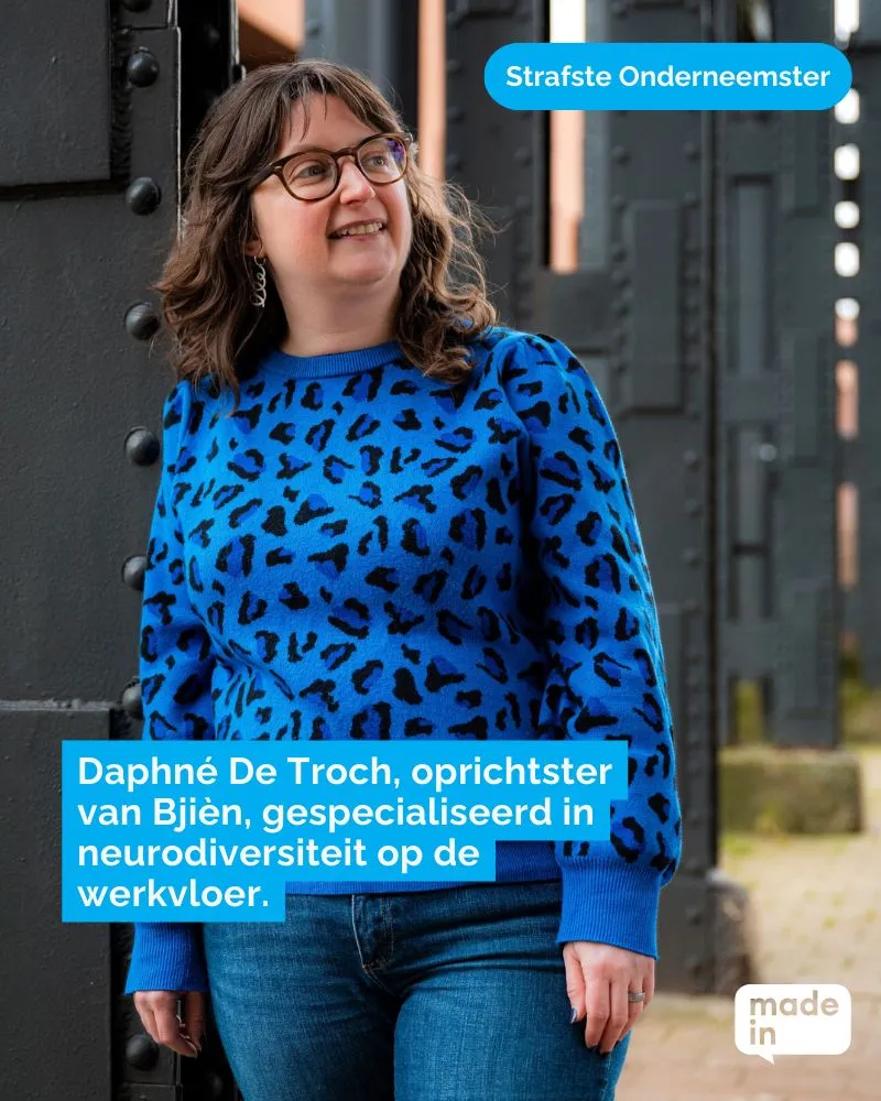 A smiling woman wearing glasses and a blue leopard-print jumper stands outdoors beside a metal structure. Dutch on-screen text describes an entrepreneur and founder of Bjien specialising in neurodiversity in the workplace.