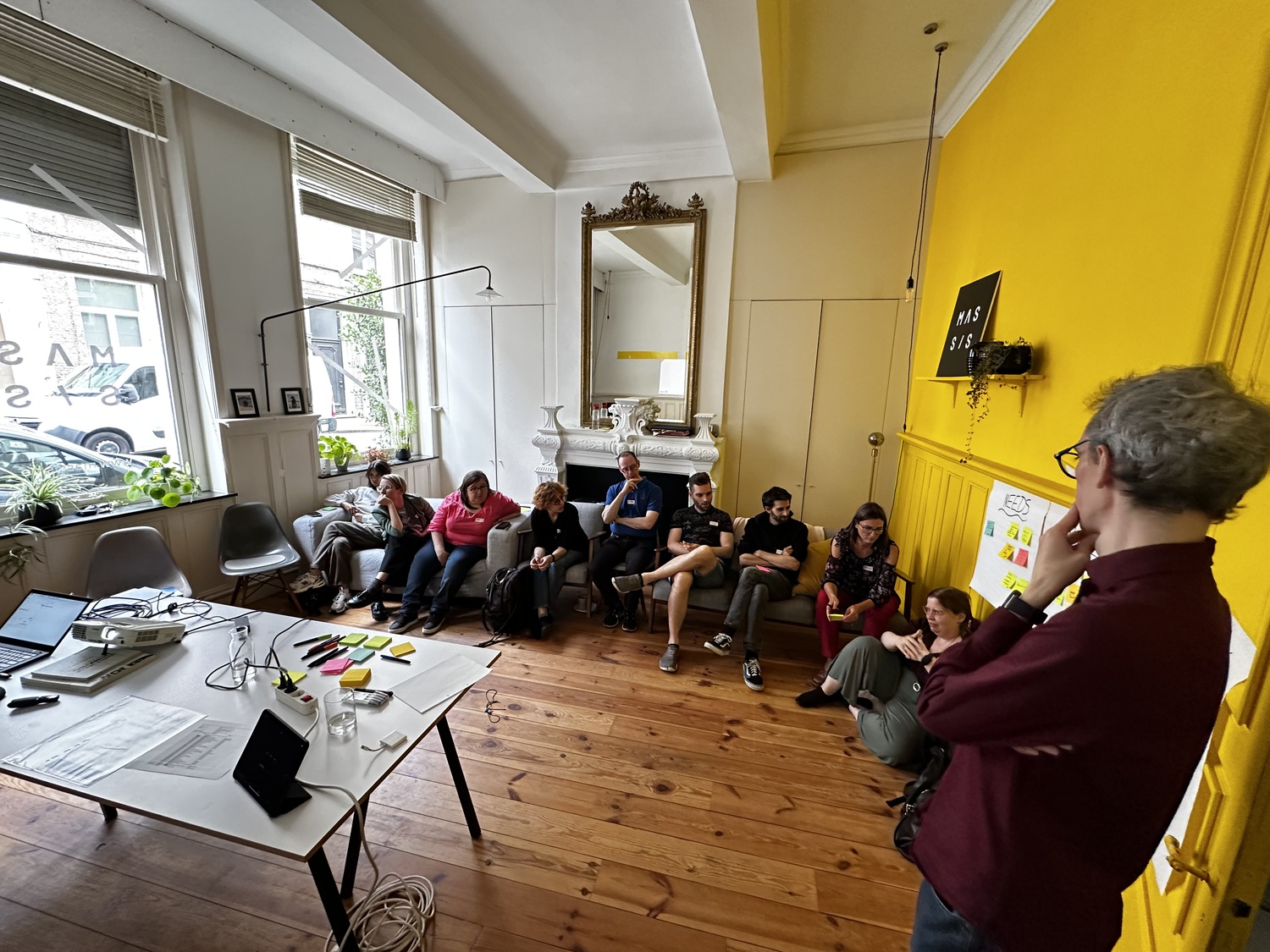 The team of Eleven Ways sitting on couches and discussing during the workshop with Bjièn.